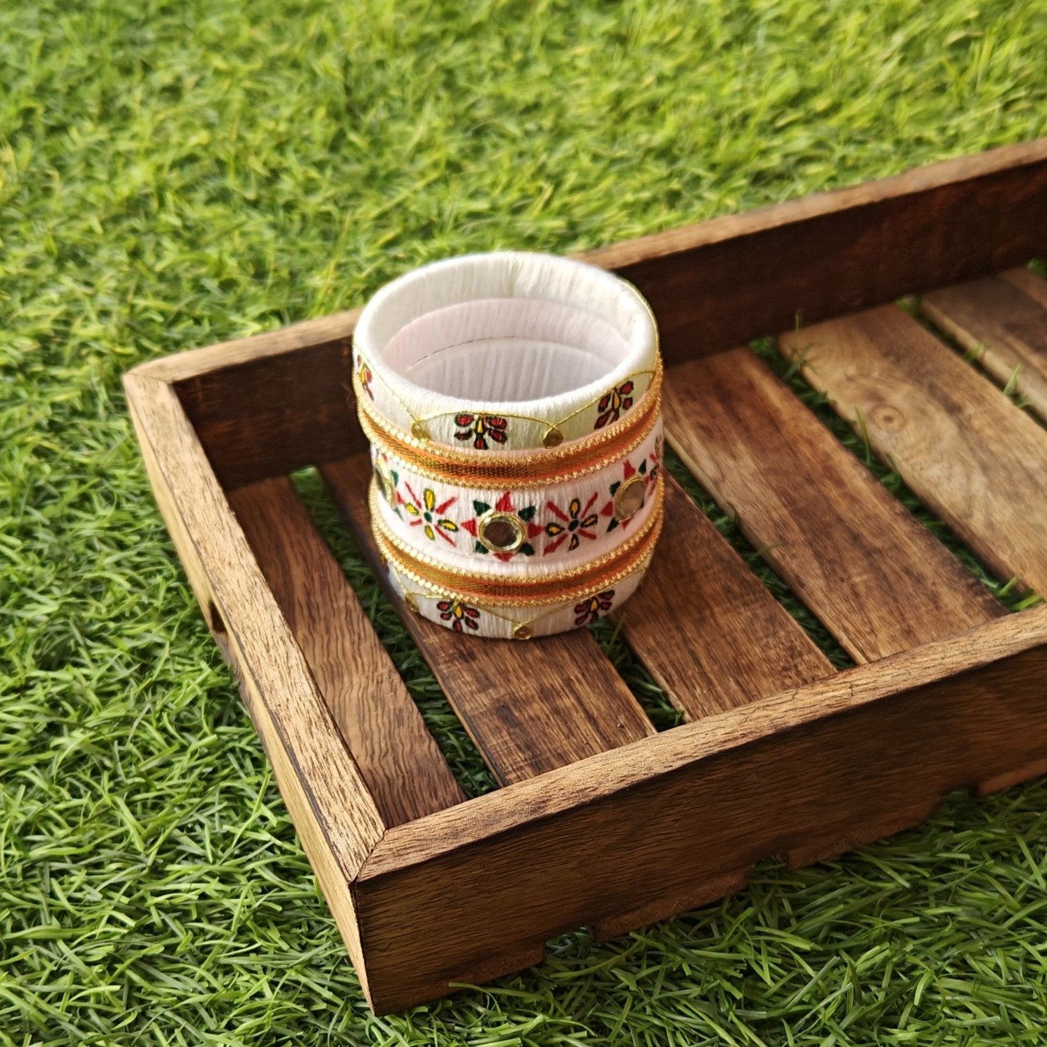 Close-up image of White Handmade Bangles with intricate detailing, designed as a timeless accessory for women.