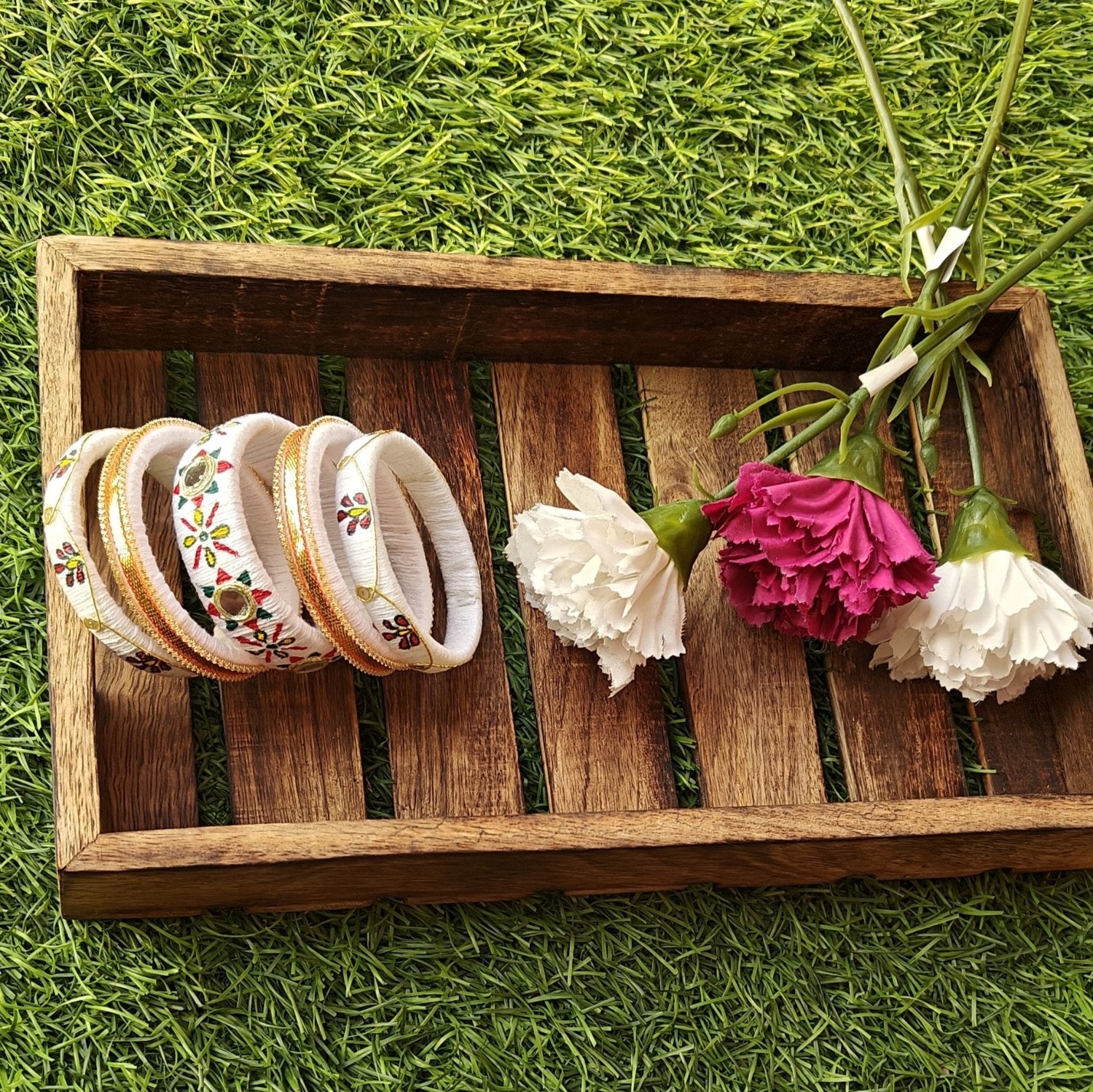 Close-up image of White Handmade Bangles with intricate detailing, designed as a timeless accessory for women.